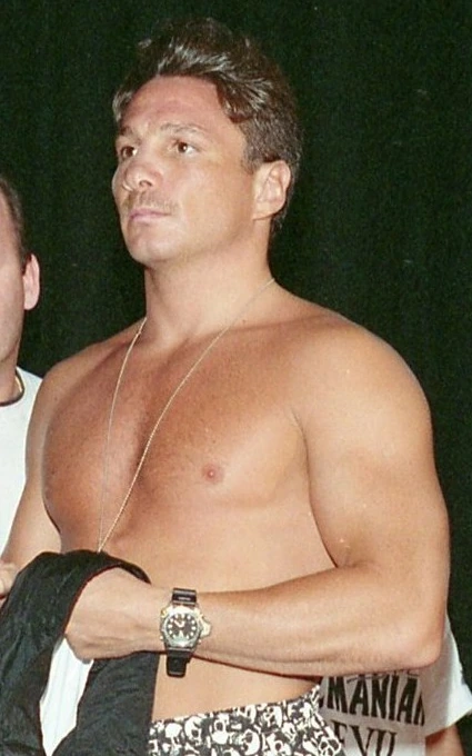 Vinny Pazienza, shirtless and wearing a necklace and watch, photographed in a candid real-life image.