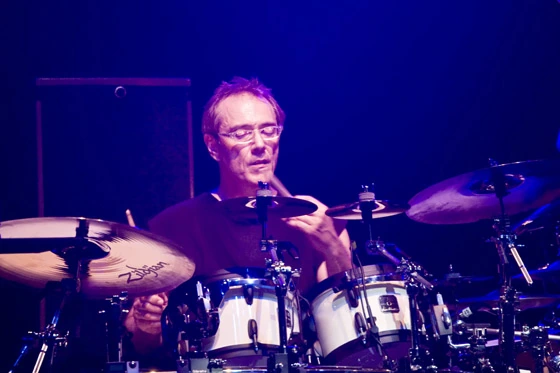 Vinnie Colaiuta performing on drums on stage.