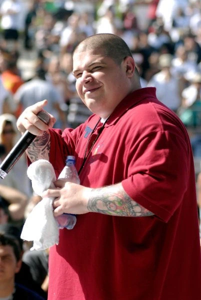 Vinnie Paz performing on stage, holding a microphone