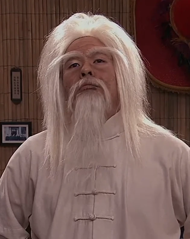Vincent Tong in character on a television set